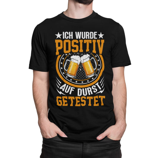 Schwarzes T-Shirt mit orangem und weißem Aufdruck „Ich wurde positiv auf Durst getestet“ und zwei anstoßenden Bierkrügen – lustiges Partyshirt für Bierliebhaber